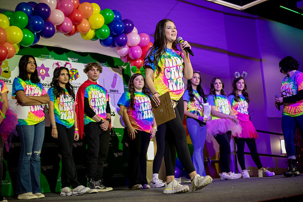 group of students standing behind another student speaking