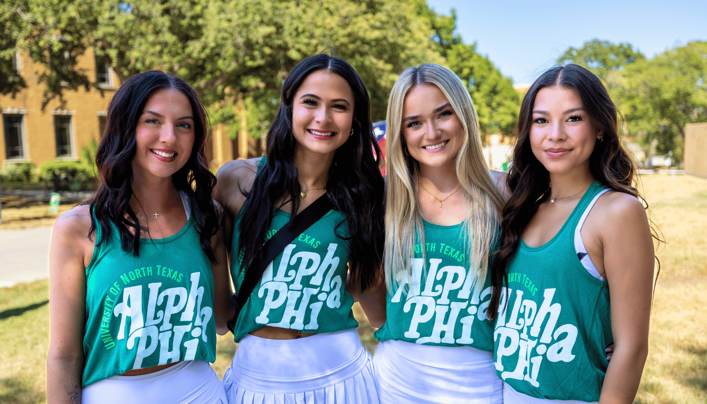 4 members of the alpha phi sorority wearing green tank tops