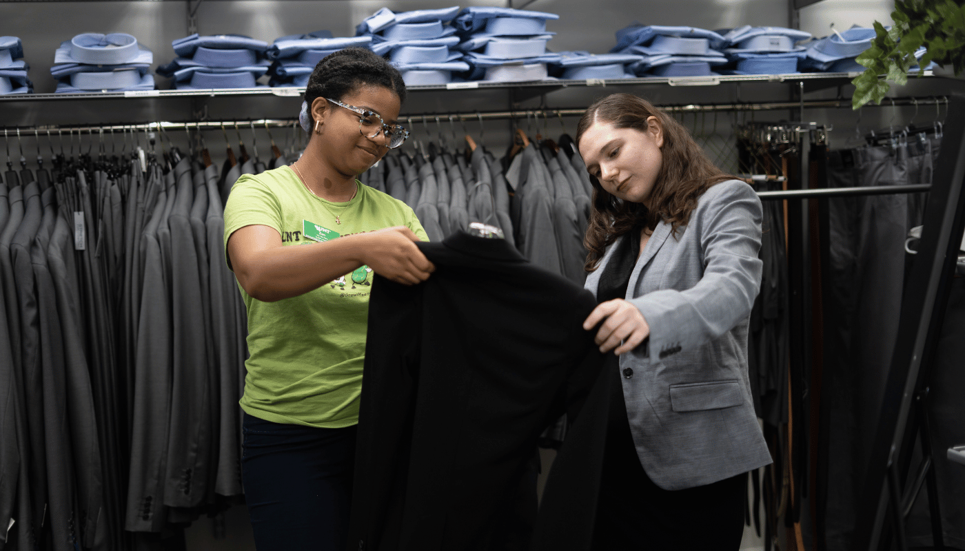suit closet two two students looking at a suit