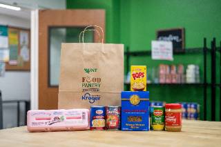A Kroger grocery bag with a variety of groceries