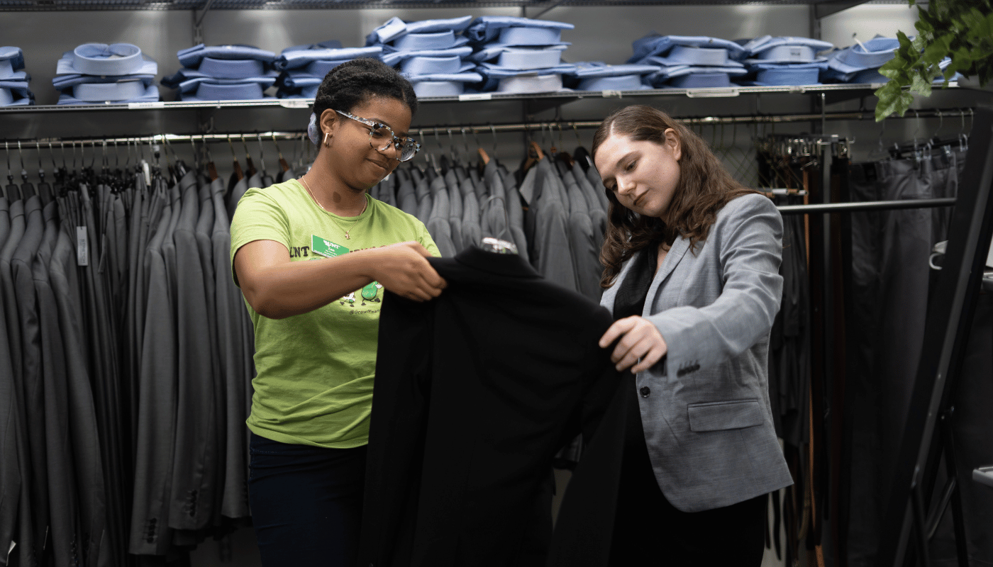 two people holding a jacket