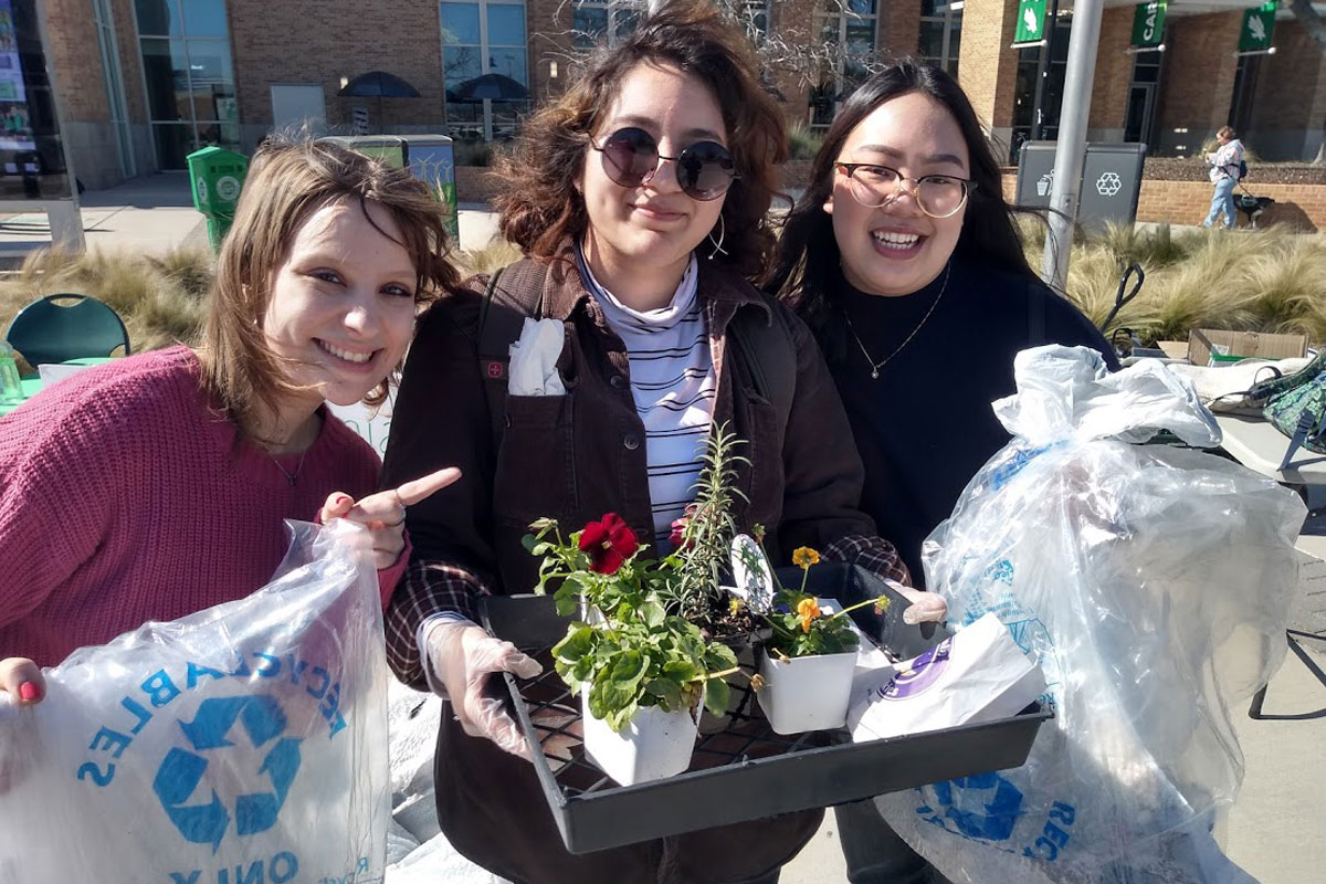 Four Students Posing for a Group Photo after a Trash Pick Up