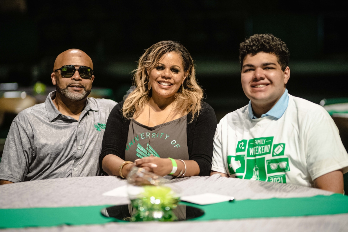 family participants at the Mean Green tailgate posing for a picture