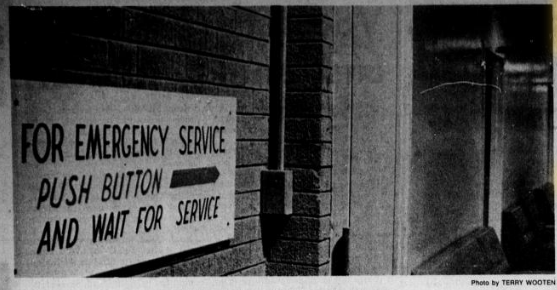 Wall with sign saying "for emergency service push button"